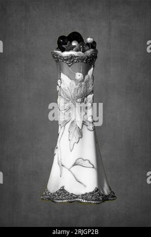 Black and White of a highly ornamented old school holder for Ladies's hat pins on a rustic background Stock Photo