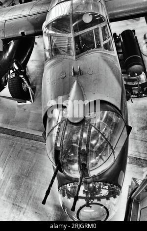 An Avro Lancaster WWII Bomber aircraft front gun turret detail at  the Imperial War Museum and airfield Duxford Stock Photo