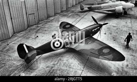 An early Supermarine Spitfire and a 1936 Lockheed 12A at the  Imperial War Museum and airfield Duxford Stock Photo