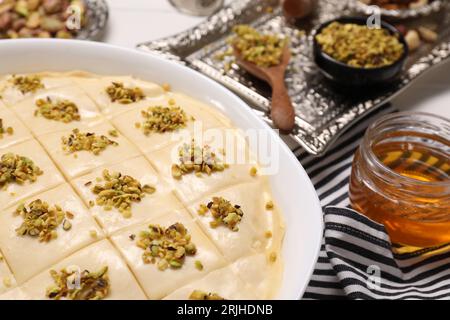 Making delicious baklava. Raw dough with ingredients on table, closeup Stock Photo