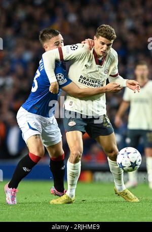 Glasgow, Scotland, 22nd August 2023.   Nicolas Raskin of Rangers and Jerdy Schouten of PSV Eindhoven during the UEFA Champions League match at Ibrox Stadium, Glasgow. Picture credit should read: Neil Hanna / Sportimage Stock Photo