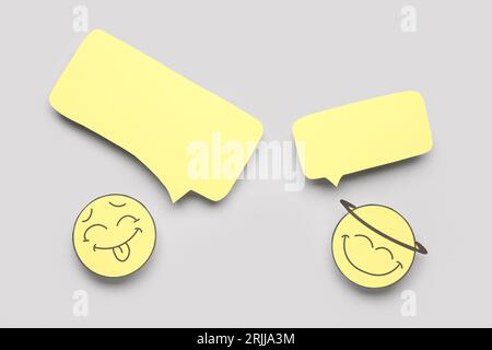 Paper faces with blank speech bubbles on grey background Stock Photo