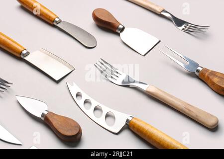 Set of knives and forks on grey background Stock Photo