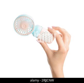 Female hand with mini electric fan on white background Stock Photo