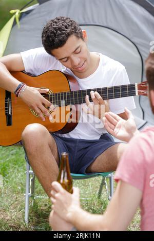 pensive man playing guitar forest Stock Photo