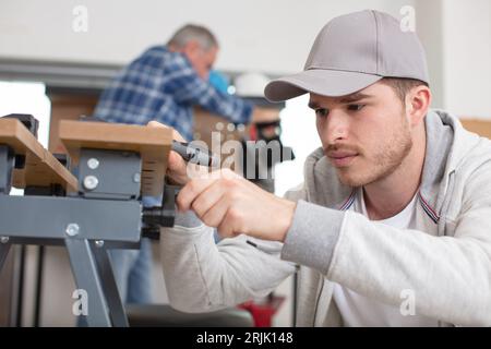carpenter with apprentice in training period Stock Photo