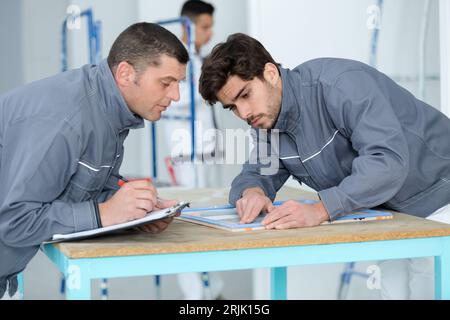warehouse managers discussing in warehouse office Stock Photo