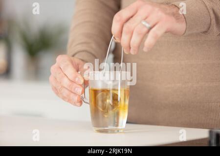 tea mug in male hands man drinking hot tea Stock Photo