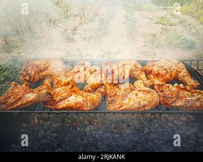 Preparing chicken legs on the grill outdoors in the garden. Baking meat at home, bio food concept Stock Photo