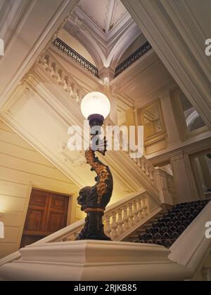 Luxurious stairwell with vintage lamp glowing in the hall of a 5 stars hotel Stock Photo