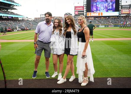 From left, retired Colorado Rockies first baseman Todd Helton is joined by  his daughter Gentry Grace, wife Christy and oldest daughter Tierney Faith  during a ceremony at which the player's number was
