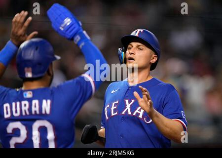 Texas Rangers' Corey Seager, Ezequiel Duran, Marcus Semien, Nathaniel Lowe  and Adolis Garcia, from left, celebrate the team's 4-2 win in a baseball  game against the Philadelphia Phillies, Wednesday, June 22, 2022