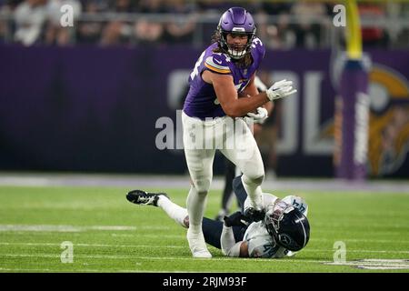 Minnesota Vikings tight end Nick Muse (34) breaks a tackle by Tennessee  Titans safety Mike Brown (44) during the first half of an NFL football  game, Saturday, Aug. 19, 2023, in Minneapolis. (