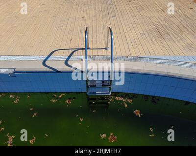 aerial view of a swimming pool with green water in autumn Stock Photo