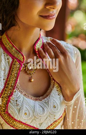 smiling indian woman in traditional attire posing with praying hands ...