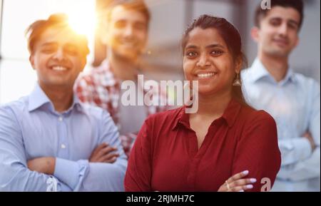 smiling pretty girl standing professionally with her arms crossed at home, hoping for a new opportunity concept Stock Photo