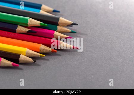 Colored pencils on gray background the concept of a multinational family and equality in the world. Stock Photo