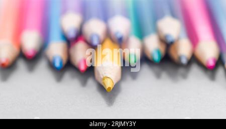 Colored pencils laying in row. Set of crayons, art, studying. Ready for school stuff. Stock Photo