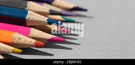 Set of colored pencils on grey table. Stock Photo