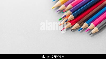 Colored pencils on the grey background. Ready for school stuff. Stock Photo