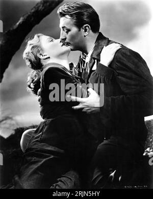 VIRGINIA HUSTON and ROBERT MITCHUM in OUT OF THE PAST / BUILD MY GALLOWS HIGH 1947 director JACQUES TOURNEUR novel / screenplay Daniel Mainwaring (as Geoffrey Holmes) music Roy Webb RKO Radio Pictures Stock Photo