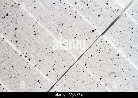 Abstract close up texture photo of compressed white with black dots styrofoam blocks Stock Photo