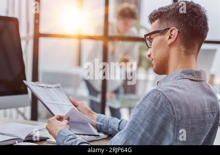 Focused businessman analyzing statistics busy with research project Stock Photo