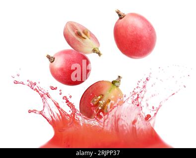 Grapes falling into juice on white background Stock Photo