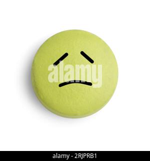 Yellow pill with sad face on white background Stock Photo - Alamy