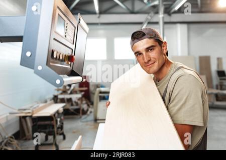 Young man doing woodwork in carpentry factory Stock Photo