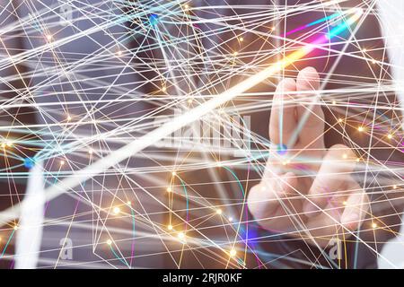 A man navigating a hologram featuring abstract network lines Stock Photo