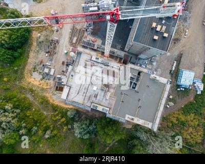 An aerial shot of a bustling construction site, featuring tower cranes and a variety of machinery Stock Photo