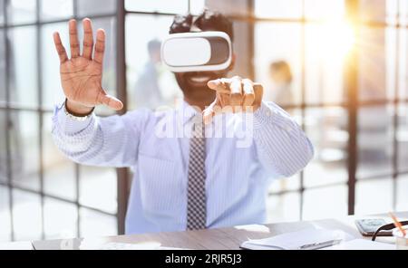 young businessman wearing virtual reality glasses in the office Stock Photo