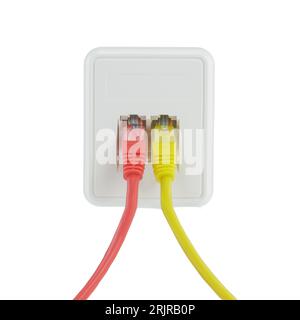 Two Ethernet cables, one yellow and one red, connected to a white network switchbox isolated on the white background Stock Photo