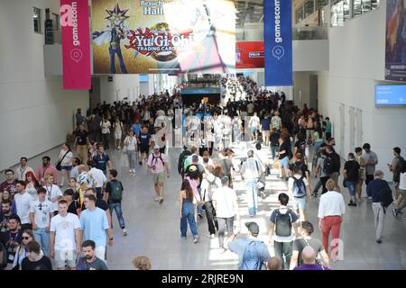 Cologne, Germany. 23rd Aug, 2023. Visitors to the Gamescom games fair walk through one of the exhibition halls. Credit: Sascha Thelen/dpa/Alamy Live News Stock Photo