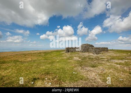 The stone shelter in shape of a cross on the summit of Cross Fell, highest point of the Pennines, Eden Valley, Cumbria Stock Photo