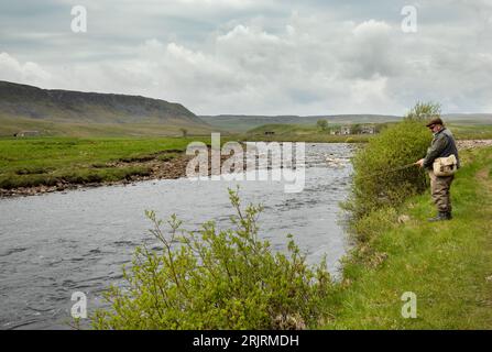 Fly fisherman on Harwood Beck which joins the upper River Tees near Wheysike House, Upper Teesdale, County Durham Stock Photo