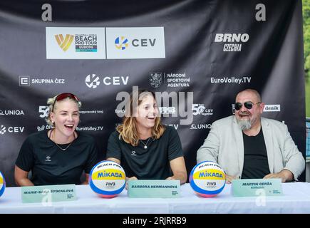 Brno, Czech Republic. 23rd Aug, 2023. L-R Czech beach volleyball players Marie-Sara Stochlova and Barbora Hermannova and Czech Volleyball Association (CVS) Deputy Chairman Martin Gerza attend the press conference prior to the Brno Beach Pro 2023 tournament, part of the Beach Pro Tour world series, on August 23, 2023, on the Brno Dam, Czech Republic. Credit: Monika Hlavacova/CTK Photo/Alamy Live News Stock Photo