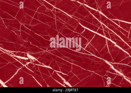 A close-up of a vibrant red, marbled surface Stock Photo