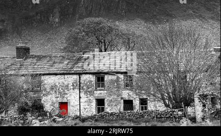 Cronkley Scar and crags of the Whin Sill with the old abandoned farmhouse of Wheysike House on Harwood Beck near to its confluence with the River Tees Stock Photo