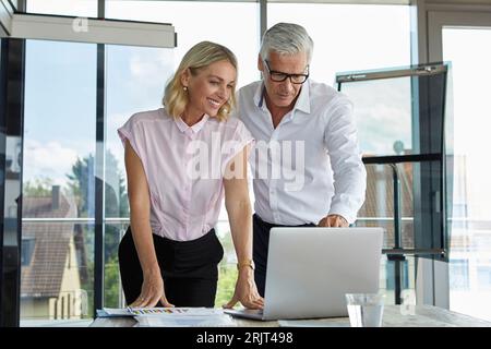 Businessman and woman discussing project in office Stock Photo