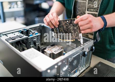 Close-up of teenager assembling personal computer Stock Photo