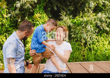 Happy family spending leisure time on footbridge Stock Photo