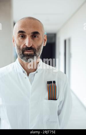 Scientist standing with multicolored computer cable in pocket Stock Photo