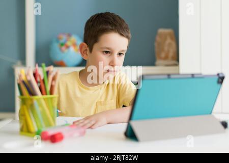Boy using tablet PC at home Stock Photo