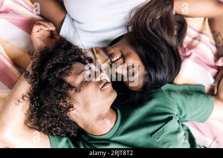 Smiling couple lying on blanket Stock Photo