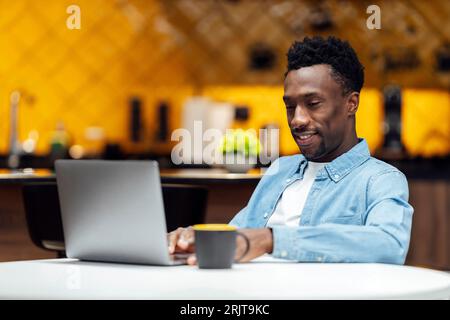 Smiling businessman using laptop at workplace Stock Photo