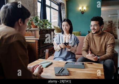 Young business colleagues having discussion Stock Photo