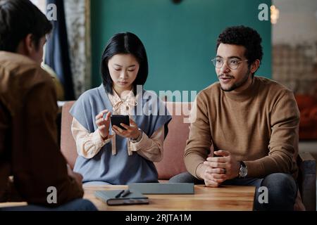 Young business people having meeting in cafe Stock Photo