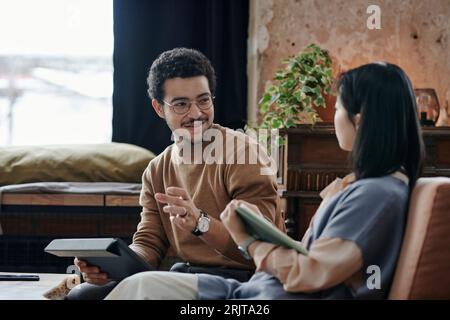 Young business partners having meeting in cafe Stock Photo